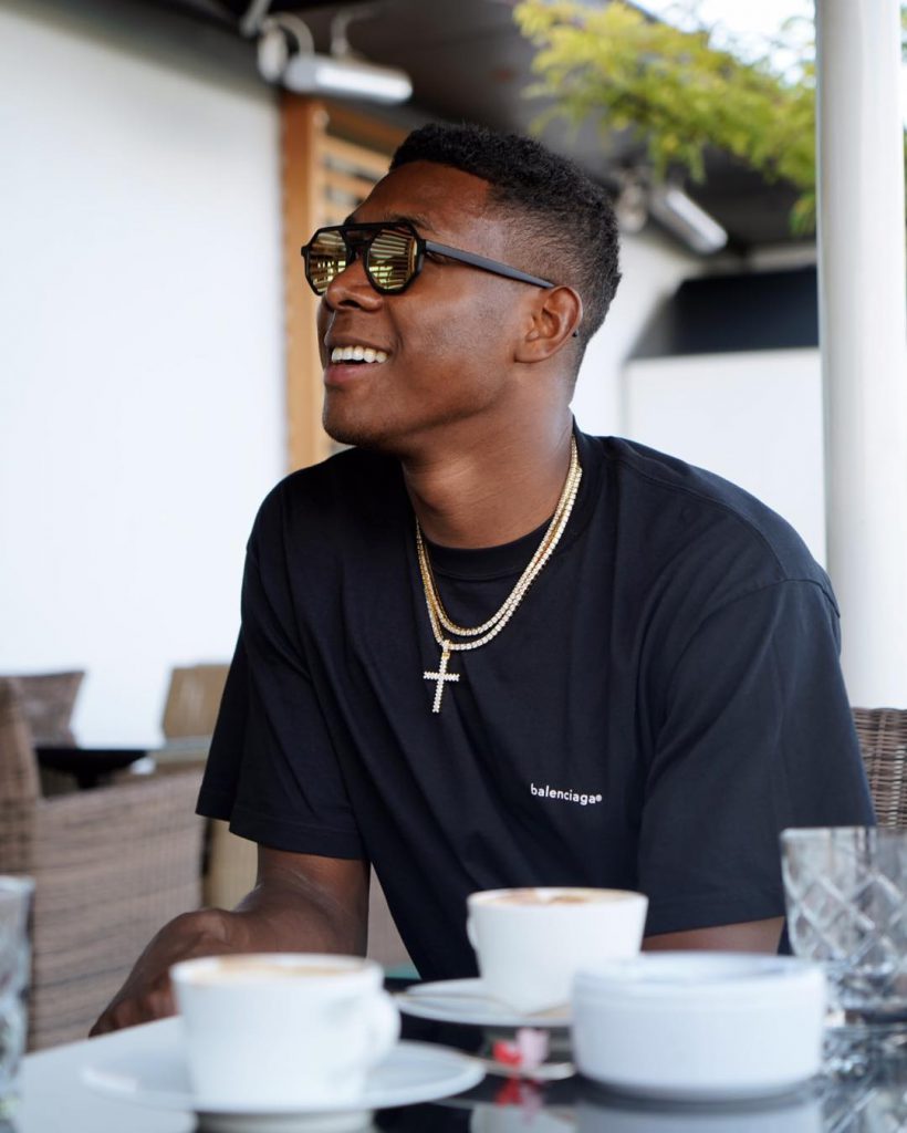 David Alaba wearing a street style outfit with fashionable sunglasses