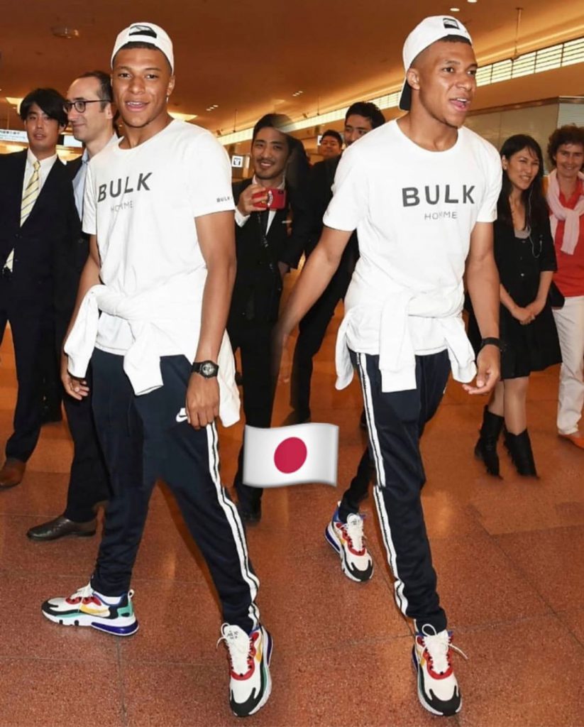 Kylian Mbappe with a white street style outfit