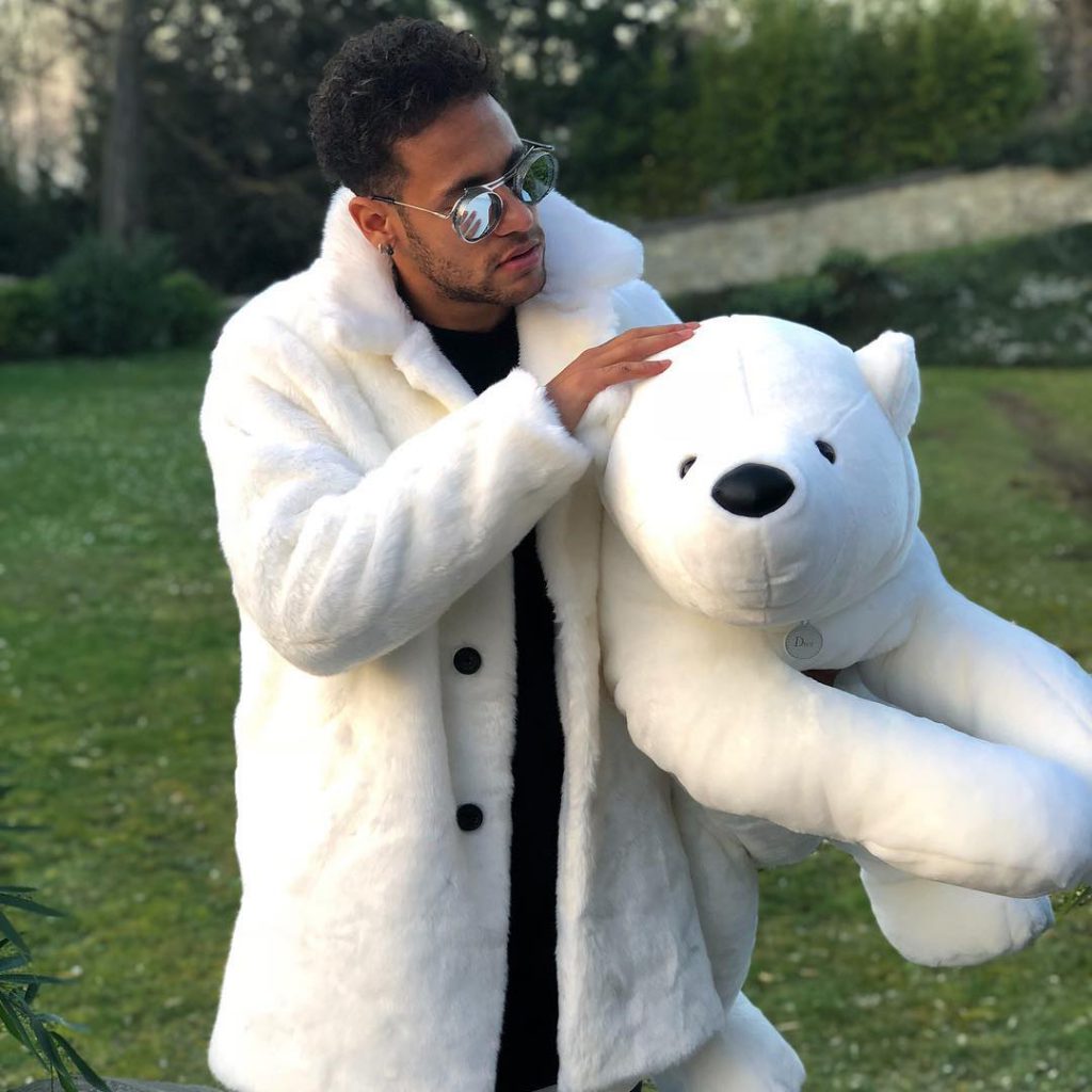 Neymar street style look in a white fur coat
