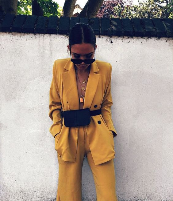 Girl wearing a yellow blazer with a Fanny Pack